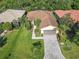 Beautiful single-Gathering home with a well-manicured lawn and paved driveway, surrounded by lush greenery and mature trees at 343 Scripps Ranch Rd, Poinciana, FL 34759