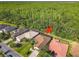 Aerial shot of backyard featuring screened-in pool, manicured lawn, and backing to green space in quiet neighborhood at 343 Scripps Ranch Rd, Poinciana, FL 34759