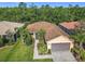 Charming single-Gathering home featuring a brick-paved driveway, well-maintained landscaping, and a serene backdrop of lush trees at 343 Scripps Ranch Rd, Poinciana, FL 34759