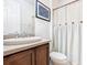 Bright bathroom featuring white shower curtain and a modern vanity at 343 Scripps Ranch Rd, Poinciana, FL 34759