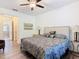 Bright bedroom featuring a ceiling fan and an ensuite bathroom at 343 Scripps Ranch Rd, Poinciana, FL 34759