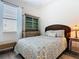 Cozy bedroom with a decorative furniture cabinet, a window, and a plush bed at 343 Scripps Ranch Rd, Poinciana, FL 34759