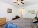 Bedroom features a ceiling fan and ensuite bathroom access at 343 Scripps Ranch Rd, Poinciana, FL 34759