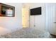 Bright bedroom featuring a wall-mounted TV and ample natural light at 343 Scripps Ranch Rd, Poinciana, FL 34759