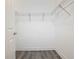 Empty walk-in closet with wire shelving and wood-look flooring at 343 Scripps Ranch Rd, Poinciana, FL 34759