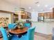 Open dining area featuring wood table with blue chairs and views into the kitchen and living room at 343 Scripps Ranch Rd, Poinciana, FL 34759