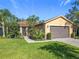Charming single-story home with a well-manicured lawn and a two-car garage at 343 Scripps Ranch Rd, Poinciana, FL 34759