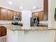 Kitchen featuring granite countertops and stainless steel appliances with a breakfast bar overlooking the living area at 343 Scripps Ranch Rd, Poinciana, FL 34759