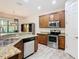 Modern kitchen with stainless steel appliances, granite countertops, and ample cabinet space at 343 Scripps Ranch Rd, Poinciana, FL 34759