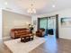 Comfortable living room with a stylish area rug and access to the outdoor patio at 343 Scripps Ranch Rd, Poinciana, FL 34759