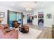 Open-concept living room with hardwood floors and plenty of natural light at 343 Scripps Ranch Rd, Poinciana, FL 34759