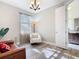 Well-lit living room featuring hardwood floors, a comfy chair and sleek leather couch at 343 Scripps Ranch Rd, Poinciana, FL 34759
