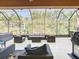 Spacious screened patio with comfortable seating and views of the green outdoors at 343 Scripps Ranch Rd, Poinciana, FL 34759