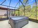 Screened patio with a large hot tub, providing a great relaxation spot at 343 Scripps Ranch Rd, Poinciana, FL 34759