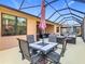 Wide angle view of a screened-in patio with a dining set and lounge area at 343 Scripps Ranch Rd, Poinciana, FL 34759