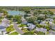 Picturesque aerial view of a residential neighborhood with a lake and lush greenery at 508 Alcazar Ct, The Villages, FL 32159