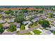 Overhead view of a lovely neighborhood featuring mature trees, manicured lawns, and beautiful homes at 508 Alcazar Ct, The Villages, FL 32159