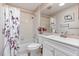 Bathroom with a vanity, toilet, and shower featuring a floral patterned curtain at 508 Alcazar Ct, The Villages, FL 32159