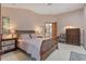 Comfortable bedroom with a wooden sleigh bed, side tables, and a dresser at 508 Alcazar Ct, The Villages, FL 32159