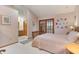 Comfortable bedroom with ensuite bathroom and access to an outside patio at 508 Alcazar Ct, The Villages, FL 32159