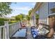 Cozy deck with wicker furniture, red chairs and table, offering a relaxing outdoor space at 508 Alcazar Ct, The Villages, FL 32159
