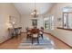 Bright dining room with a chandelier, wood-look floors, and large windows that bring in natural light at 508 Alcazar Ct, The Villages, FL 32159