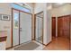Bright foyer featuring a glass-paneled front door, a mirrored closet door, and wood-look flooring at 508 Alcazar Ct, The Villages, FL 32159