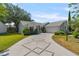 Beautiful single-story home featuring a spacious driveway and lush landscaping on a sunny, clear day at 508 Alcazar Ct, The Villages, FL 32159