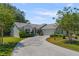 Beautiful single-story home featuring a spacious driveway and lush landscaping on a sunny, clear day at 508 Alcazar Ct, The Villages, FL 32159