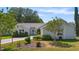 Charming single-story home featuring lush landscaping, a well-manicured lawn, and a welcoming entrance at 508 Alcazar Ct, The Villages, FL 32159