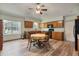 Eat-in kitchen featuring wood cabinets, granite countertops, a ceiling fan, and a casual dining space at 508 Alcazar Ct, The Villages, FL 32159