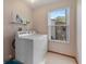 Laundry room with a washing machine, dryer, and a window that provides natural light at 508 Alcazar Ct, The Villages, FL 32159