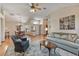 Open-concept living room leading to the dining room with vaulted ceilings and laminate wood floors at 508 Alcazar Ct, The Villages, FL 32159
