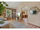 Comfortable living room with bookshelf leading into a bright kitchen at 508 Alcazar Ct, The Villages, FL 32159