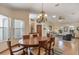 Light-filled living room and dining room with vaulted ceilings and laminate wood floors at 508 Alcazar Ct, The Villages, FL 32159