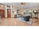 Inviting living room with vaulted ceilings, cozy furnishings, and laminate wood floors at 508 Alcazar Ct, The Villages, FL 32159