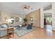 Inviting living room boasts vaulted ceilings, a ceiling fan, wood-look floors, and ample natural light at 508 Alcazar Ct, The Villages, FL 32159