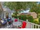 A delightful outdoor patio features comfortable wicker furniture and a peaceful view of the surrounding greenery at 508 Alcazar Ct, The Villages, FL 32159