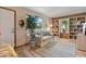 Cozy sitting room with built-in bookshelves, wood-look flooring, and natural light from two large windows at 508 Alcazar Ct, The Villages, FL 32159