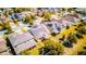 Aerial view of multiple homes with solar panels, manicured lawns, and tree-lined streets at 5118 Tiber Way, St Cloud, FL 34771