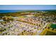 An aerial view of a planned community featuring residential homes, green spaces, and waterways at 5118 Tiber Way, St Cloud, FL 34771