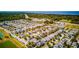 Scenic aerial view of a residential community featuring lush greenery and a glimpse of the ocean at 5118 Tiber Way, St Cloud, FL 34771