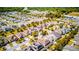Expansive aerial view of a neighborhood with tree-lined streets and well-maintained homes at 5118 Tiber Way, St Cloud, FL 34771