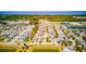 Overhead view of a neighborhood near a lake, featuring tree-lined streets and Gathering homes at 5118 Tiber Way, St Cloud, FL 34771