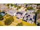 Aerial view of homes with solar panels, backyard patio, and white fence on well-manicured lawns at 5118 Tiber Way, St Cloud, FL 34771