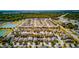 Expansive aerial shot of the community featuring numerous homes, ponds, and lush green landscapes at 5118 Tiber Way, St Cloud, FL 34771