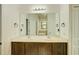 Bathroom featuring double sinks, large mirror, vanity with dark wood cabinets, and marble countertop at 5118 Tiber Way, St Cloud, FL 34771
