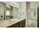 Bathroom with a double sink vanity, a large mirror, and multiple doorways at 5118 Tiber Way, St Cloud, FL 34771
