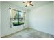 Bedroom with carpet, a ceiling fan, and a large window at 5118 Tiber Way, St Cloud, FL 34771