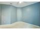 Blue bedroom featuring natural light, neutral carpet, and ceiling fan at 5118 Tiber Way, St Cloud, FL 34771